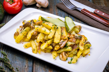 Fried potatoes with mushrooms