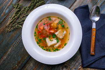 Fish soup on white plate