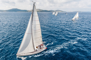 Sailing boats from bird view on open sea