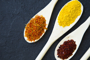 Set of specis and herbs on black stone background