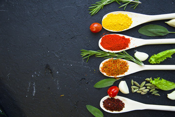 Set of specis and herbs on black stone background