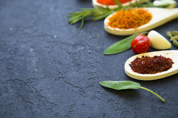 Set of specis and herbs on black stone background