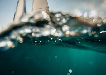 Underwater view of sailing boat, dramatic atmosphere