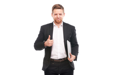 Studio portrait of young manager in suit holding laptop on white background