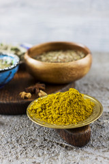 Curry powder and spices on a wooden Board