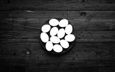 Chicken egg on a dark wooden background, free space for text.