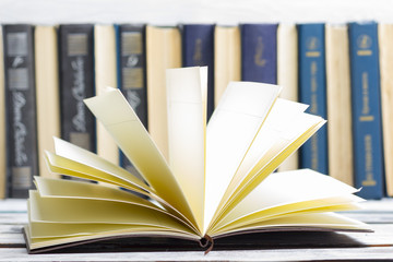 Naklejka premium Open book, hardback books on wooden table. Back to school. Copy space