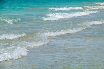 Fototapeta na wymiar Tropical beach washed by a wave of the ocean