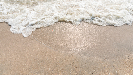 Sea beach with sand. Water wavey