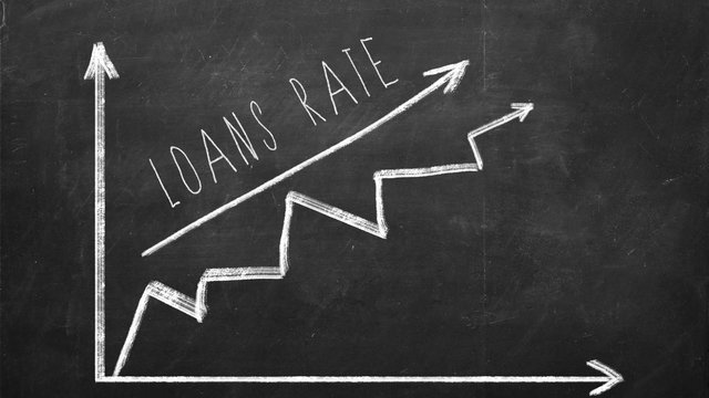 Loans rate. Growing Line graph drawn with chalk on blackboard