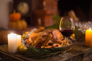 Roasted Turkey. Thanksgiving table served with turkey, decorated with bright autumn leaves and candles. Roasted chicken, table setting. Christmas dinner