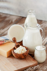 Set of different milk products on ristic wooden table
