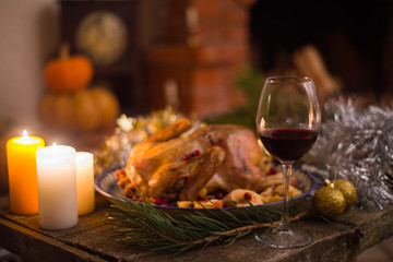 Roasted Turkey. Thanksgiving table served with turkey, decorated with bright autumn leaves and candles. Roasted chicken, table setting. Christmas dinner