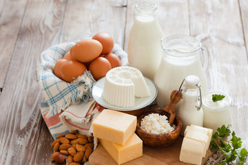 Set of different milk products on ristic wooden table