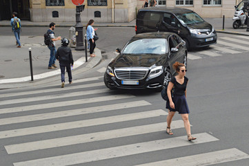 Street moment. Woman goes on cross road