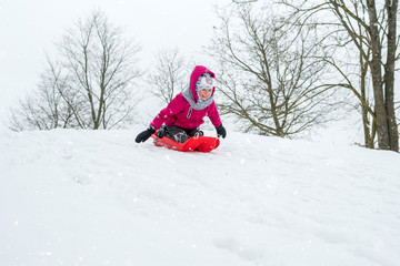 Fototapeta na wymiar Girl with sleds outdoors on winter day