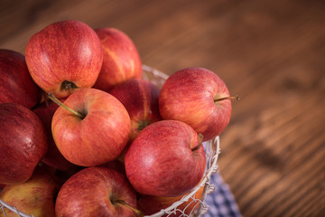 close up of red fruit apples on a wood background 