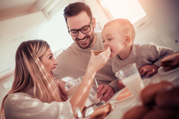 Obraz na płótnie Canvas Happy family having breakfast at home