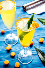 cocktail with physalis in glass on wooden background