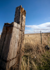 Broken Fence on a farm with blue skies