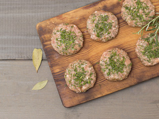 cutlets from minced pork on a wooden table. 