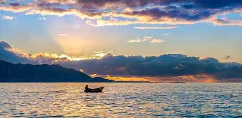 Beautiful view of a boat sailing at sunset in Gradac Croatia