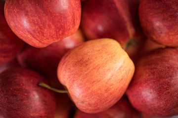 close up of red fruit apples on a wood background 