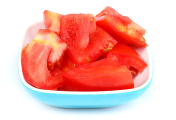 Tomato slices in a plastic bowl