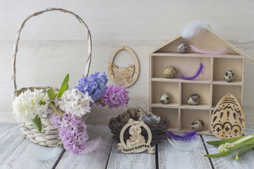 Fototapeta na wymiar Easter background: hyacinths in a basket, rabbits, Easter decor and quail eggs