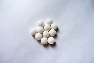Fistful  of small white vitamin k tablets