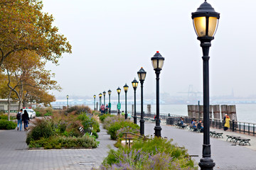 Seafront of New York city on day with heavy fog in autumn, Battery Park.
