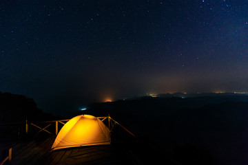 Fototapeta na wymiar Lonely camping on the mountain under the stars and blue sky.