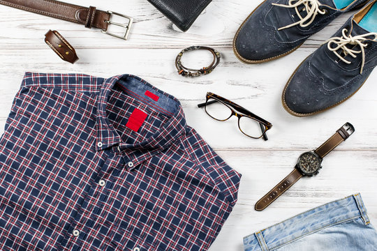 Men stylish casual clothing and accessories on wooden background.