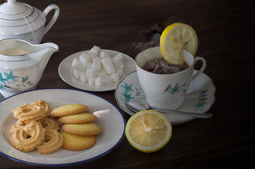 English tea with lemon and Cookies on brown wooden table, Still Life style