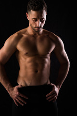 Fototapeta na wymiar Fitness session in madrid's photographic studio with a boy without a shirt