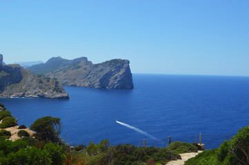 Sunny sea view with yacht and mountains