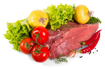 Piece of fresh veal, onion, pepper, garlic, top of lettuce leaf isolated on white