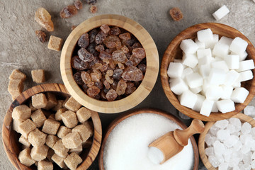 Various types of sugar, brown sugar and white on table