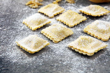 Various mix of pasta on grey rustic background. Diet and food concept.