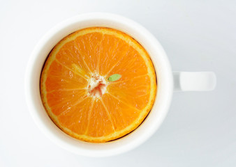 Orange slice in white cup with white tube isolated on white background
