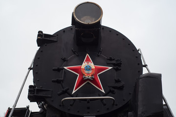 An old Soviet steam locomotive with a star of the USSR