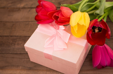 bouquet of tulips with a pink gift