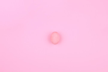 Happy Easter Day. Pink tradition easter egg on center of pink background