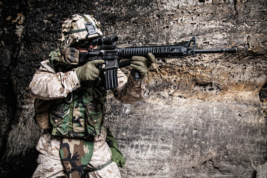 US Marine Corps Soldier in action among the rocks