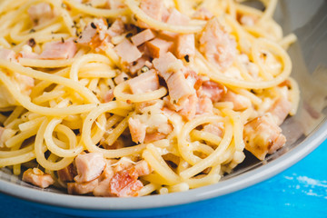 Tasty pasta with bacon and cheese. Selecitve focus.