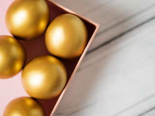 Golden Easter eggs in gift box copy space