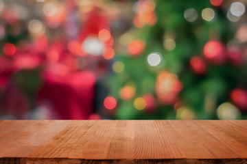 Wood table top on blur Christmas tree background - can be used for display or montage your products