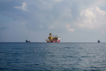 Obraz premium Photo of sea with floating cargo ship