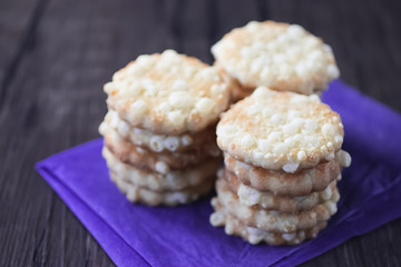 Cheese biscuits on purple paper.