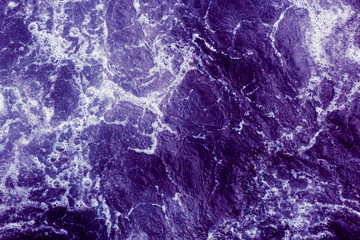 Abstract purple background with waves and foam